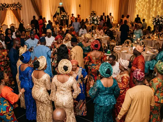 Guests in colourful aso-ebi dancing at a Nigerian celebration
